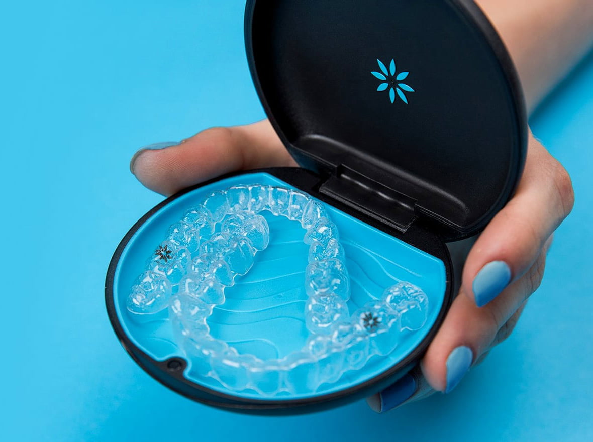 A close-up of Invisalign aligners being cleaned, ensuring proper hygiene during orthodontic treatment.