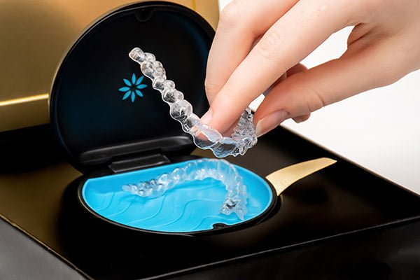 A dentist fitting a patient with customized Invisalign aligners, ensuring a perfect fit for optimal results.